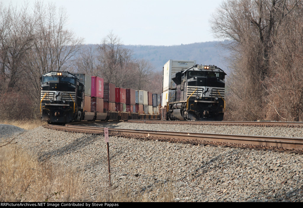 NS 1135 leads train 294 east past a stack train on the siding